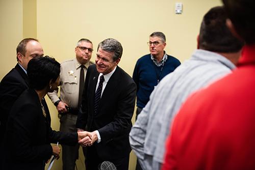 Governor Cooper shaking hands with Rowan-Cabarrus staff